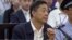 In this image taken from video, Chinese politician Bo Xilai looks up in a court room at Jinan Intermediate People's Court in Jinan, eastern China's Shandong province, Aug. 26, 2013.