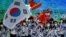 South Korea's flag bearer Kwak Yoon-gy and South Korea's flag bearer Kim A-lang lead the delegation during the opening ceremony of the Beijing 2022 Winter Olympic Games at the National Stadium in Beijing on Feb. 4, 2022. 