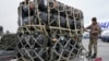 Ukrainian servicemen unpack Javelin anti-tank missiles, delivered as part of US security assistance to Ukraine, at the Boryspil airport outside Kyiv, Feb. 11, 2022.