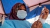 FILE - A nurse prepares to administer a vaccination against COVID-19, at a district health center in the low-income Kibera neighborhood of Nairobi, Kenya, Jan. 20, 2022.