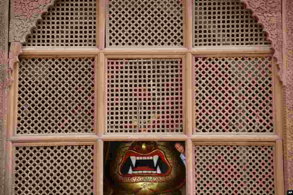 A Priest looks out from the temple of Swet Bhairabh in Basantapur Durbar Square in Kathmandu, Nepal.