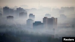 Syrian children line up to receive food from aid workers at an camp for displaced people in Aleppo Governorate near the Bab al-Salamah border crossing between Syria and Turkey.