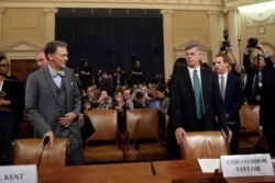 Top U.S. diplomat in Ukraine William Taylor, right, and career Foreign Service officer George Kent arrive to testify before the House Intelligence Committee on Capitol Hill in Washington, Nov. 13, 2019.