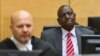 Kenya's Deputy President William Ruto (R) reacts as he sits in the courtroom before his trial at the International Criminal Court (ICC) in The Hague, Sept. 10, 2013.