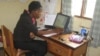 Hotline worker Hanna James assists a caller at Balaka Centre in Malawi, Jan. 13, 2014. (Lameck Masina/VOA) 