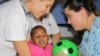 Laura Grobicki (left) and Stephanie Benn give therapy to a patient with cerebral palsy at Zithulele Hospital in South Africa ( Photo D.Taylor) 