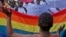 FILE - People protest against the sentencing of two men in Malawi under Malawi's anti-gay legislation in Cape Town, South Africa, May 20, 2010. Two Kenyan men have filed a constitutional petition against forced anal examinations to "prove homosexuality."