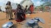 Kadija Mohamed cooks food for her children in a camp set up for internally displaced people in Dinsoor, in southern Somalia, January 5, 2012.