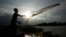 A construction worker casts a fishing net onto a flooded land following recent rain to catch fish on the outskirts of Phnom Penh, Cambodia, Thursday, June 11, 2020. (AP Photo/Heng Sinith)