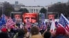 FILE - President Donald Trump, seen on jumbotrons, speaks at a rally of his supporters in Washington, Jan. 6, 2021, just prior to hundreds of them storming the U.S. Capitol.