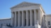 Visitors walk outside the Supreme Court building in Washington, Feb. 21, 2022.