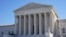 Visitors walk outside the Supreme Court building in Washington, Feb. 21, 2022.