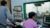 VOD Roundtable producers do final audio and video checks before going live with host Lim Thida, far right, and guest Yi Soksan of Adhoc, at VOD's studio, in Phnom Penh, Sept. 11, 2019. (Tum Malis/VOA Khmer)