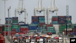 Cargo trucks wait in line at the Port of Long Beach, in Long Beach, Calif., Feb. 17, 2015.