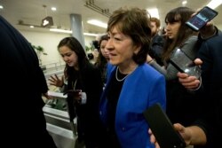 FILE - Senator Susan Collins R-ME talks to reporters before attending the impeachment trial of President Donald Trump on charges of abuse of power and obstruction of Congress, Jan. 28, 2020, on Capitol Hill in Washington.
