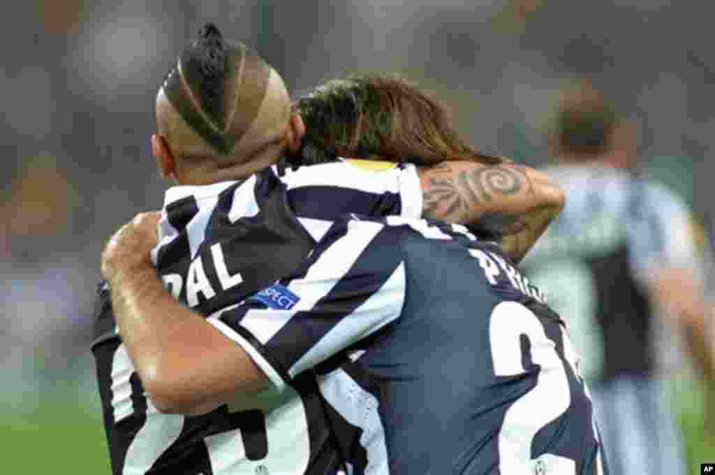 Arturo Vidal, left, of Chile, celebrates with his teammate during the Europa League quarterfinal soccer match between Juventus and Olympic Lyon at the Juventus stadium, in Turin, Italy, Thursday, April 10. (AP Photo)