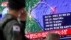 A South Korean soldier walks past a TV broadcasting a news report on North Korea firing a missile that is believed to be launched from a submarine, in Seoul, South Korea, Oct. 2, 2019. 