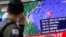 FILE - A South Korean soldier walks past a TV broadcasting a news report on North Korea firing a missile that is believed to be launched from a submarine, in Seoul, South Korea, Oct. 2, 2019. 