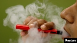 FILE - A man uses a vape device in this illustration picture, September 19, 2019. (REUTERS/Adnan Abisi/Illustration)