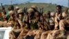 FILE - Chadian soldiers sit on a pickup truck as they leave Bangui on April 4, 2014, escorted by African-led International Support Mission to the Central African Republic (MISCA) forces (not pictured). 
