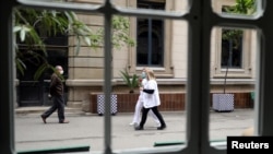 People are seen holding roses outside the Hospital Clinic on Saint George's Day (Sant Jordi), as the spread of the coronavirus disease (COVID-19) continues in Barcelona, Spain, April 23, 2020. 