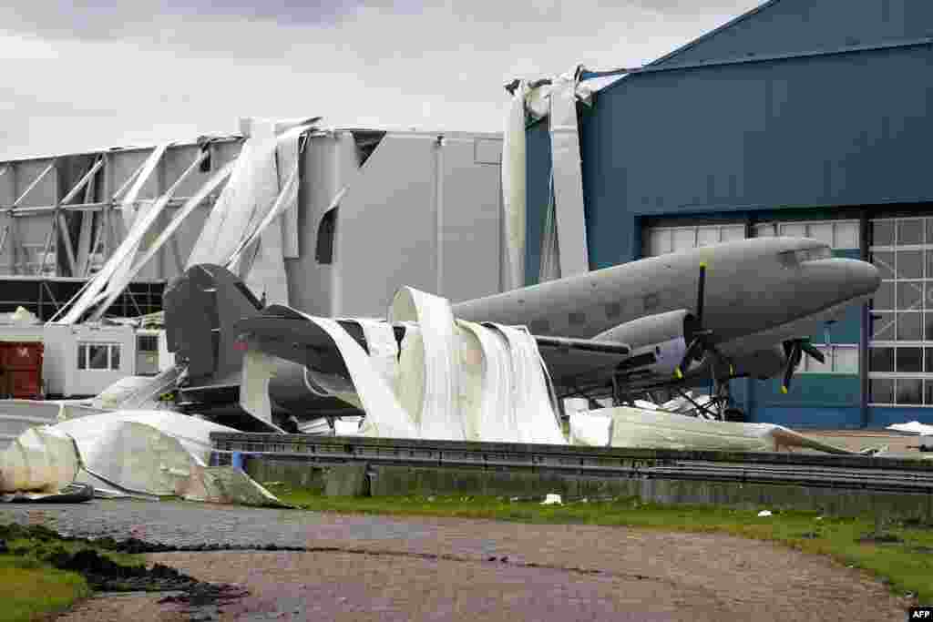 Parts of the roof of the Theatre Hangar are seen on the Dakota airplane after the roof was partially blown away by strong winds at the former airfield in Valkenburg, The Netherlands. The Dakota airplane is being used in the musical Soldier of Orange.