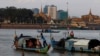 FILE PHOTO- Fishermen row their wooden boats in conjunction with rivers between the Mekong River and Tonle Sap as they catch fish during the fish harvesting season near Phnom Penh, Cambodia, Wednesday, Nov. 28, 2018. (AP Photo/Heng Sinith)
