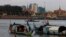 FILE PHOTO- Fishermen row their wooden boats in conjunction with rivers between the Mekong River and Tonle Sap as they catch fish during the fish harvesting season near Phnom Penh, Cambodia, Wednesday, Nov. 28, 2018. (AP Photo/Heng Sinith)
