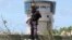 A policeman stands guard near the air-control tower of a airport following a suicide bombing near the African Union's main peacekeeping base in Mogadishu, Somalia, July 26, 2016. 