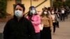 FILE - People wait in line for COVID-19 testing in Los Angeles, Dec. 7, 2020.