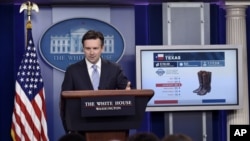 白宫发言人欧内斯特在白宫例行记者会上利用图像讨论TPP。（2015年10月13日）