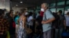 Travelers wait for a charter flight coordinated by the U.S. embassy at the La Aurora airport in Guatemala City, March 24, 2020.
