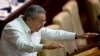 FILE - Cuban President Raul Castro gestures to lawmakers during the closing of the legislative session at the National Assembly in Havana.