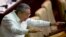 FILE - Cuban President Raul Castro gestures to lawmakers during the closing of the legislative session at the National Assembly in Havana.