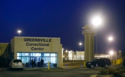 FILE - Guards stand outside the entrance to the Greensville Correctional Center, where executions are carried out, in Jarratt, Va., Sept. 23, 2010. Virginia lawmakers voted in February 2021 to end the death penalty.