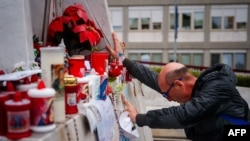 A man prays at the statue of John Paul II at the Gemelli hospital where Pope Francis is hospitalized with pneumonia, in Rome on March 1, 2025.