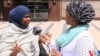 VOA Somali Service reporter Falastine Iman interviews Ayan Farah, mother of defendant Mohamed Farah outside the court in Minneapolis, Minn, May 21, 2016. 