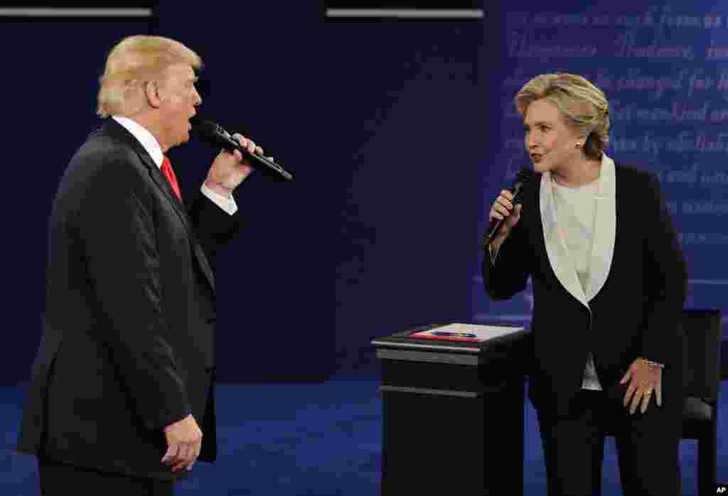 Republican presidential nominee Donald Trump and Democratic presidential nominee Hillary Clinton speak during the second presidential debate at Washington University in St. Louis, Missouri, Oct. 9, 2016.