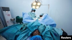 FILE - Doctors perform a fistula repair surgery on a patient in Maiduguri, Nigeria, July 31, 2018. Tuesday is the International Day to End Obstetric Fistula.