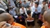 Cambodia National Rescue Party's commune chief Sieng Chet, center, is blessed by Buddhist monks outside the main prison gate of Prey Sar on the outskirts of Phnom Penh, Cambodia, Thursday, Dec. 8, 2016. Sieng Chet was released Thursday from the prison after he was convicted to five years on accusations he tried to help cover up a woman's affair with the party's deputy leader. (AP Photo/Heng Sinith)