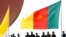 FILE - Cameroonian police stand near a national flag.