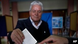 A man votes in the Presidential election in southern port city of Limassol, Cyprus, February 17, 2013.