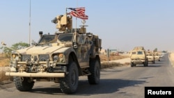 A convoy of U.S. vehicles is seen after withdrawing from northern Syria, on the outskirts of Dohuk, Iraq, October 21, 2019. 