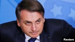 Brazil's President Jair Bolsonaro looks on during a ceremony for Government Secretary Jorge Antonio de Oliveira Francisco at the Planalto Palace in Brasilia, Brazil, June 24, 2019. 