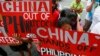 Protesters display placards during a rally at the Chinese consulate in the financial district of Makati city, east of Manila, Philippines, Nov. 12, 2015.