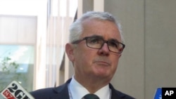 FILE - Australian lawmaker Andrew Wilkie addresses the media outside Parliament House in Canberra, Oct. 18, 2017. Wilkie accused a major Australian casino company of rigging slot machines and concealing potential money laundering.