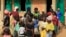 FILE - Children gather for breakfast at the Local Education primary school refugee center Bondon, Kaura Local Government Kaduna State, Nigeria, March 20, 2014. 