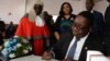 FILE - Newly elected Malawian president Peter Mutharika signs the oath book after he was sworn in, at the High Court in Blantyre, Malawi, May 31, 2014.