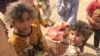 Children in this Mosul suburb, Demerche, say they rely entirely on humanitarian aid for food, and the assistance comes sporadically or sometimes not at all, in Mosul, Iraq, May 4, 2017. (H. Murdock/VOA)