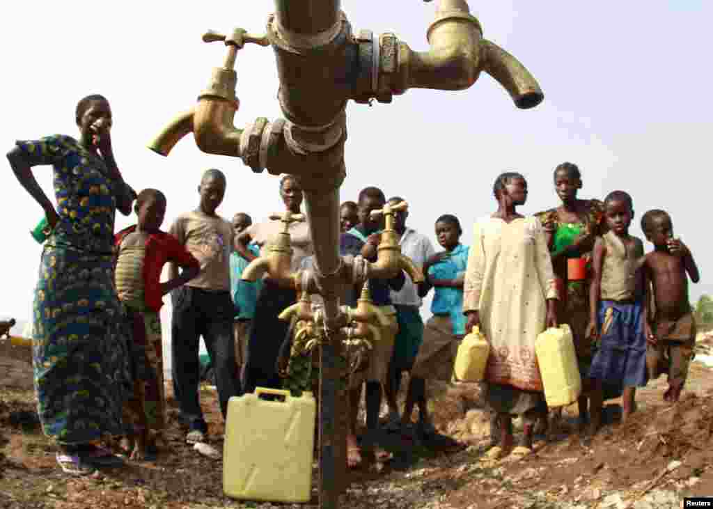 Congolese refugees, displaced by fighting between the Congo army and rebel group Allied Democratic Forces (ADF) last week, gather around dry water taps at Bukanga transit camp in Bundibugyo town camp, 376km (238 miles) southwest of Kampala, Uganda. 